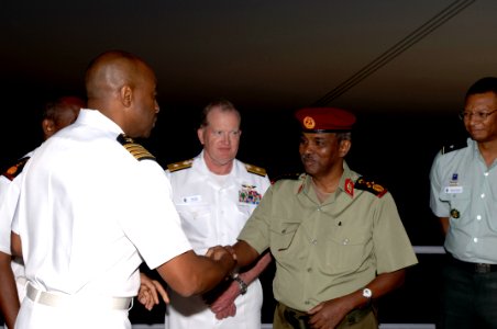 US Navy 071215-F-0509T-091 U.S. Navy Commodore Frank Ponds presents Djiboutian Army Brig. Gen. Osman Soubagleh with a coin during a reception at end the Operation Image Nautilus aboard USS Gunston Hall (LSD 44)