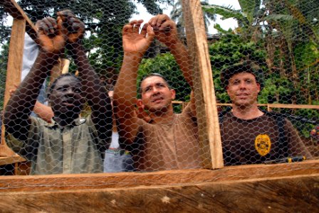US Navy 071211-N-0193M-145 Construction Electrician 2nd Class Jose Castillo, center, takes time as an Africa Partnership Station (APS) volunteer to shows Limbe United Youth Associations volunteers how to secure chicken wire