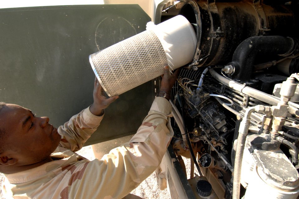 US Navy 071217-N-7027P-101 Seaman Terrance Jones of Cargo Transfer Platoon (CTP) 3 checks the air filter during maintenance checks on a 10,000lb Atlas vehicle