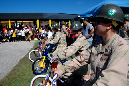 US Navy 071218-N-7367K-007 Seabees attached to Naval Mobile Construction Battalion (NMCB) 1, Guam Det. present the students of Chief Brodie Memorial Elementary School with new bicycles