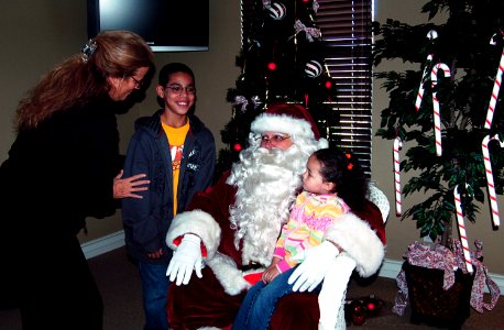 US Navy 071215-N-1752H-002 Children pose for a picture with Santa Clause during Operation Homefront's annual Gift to You event at Lincoln Military Housing's Orleck Community Center