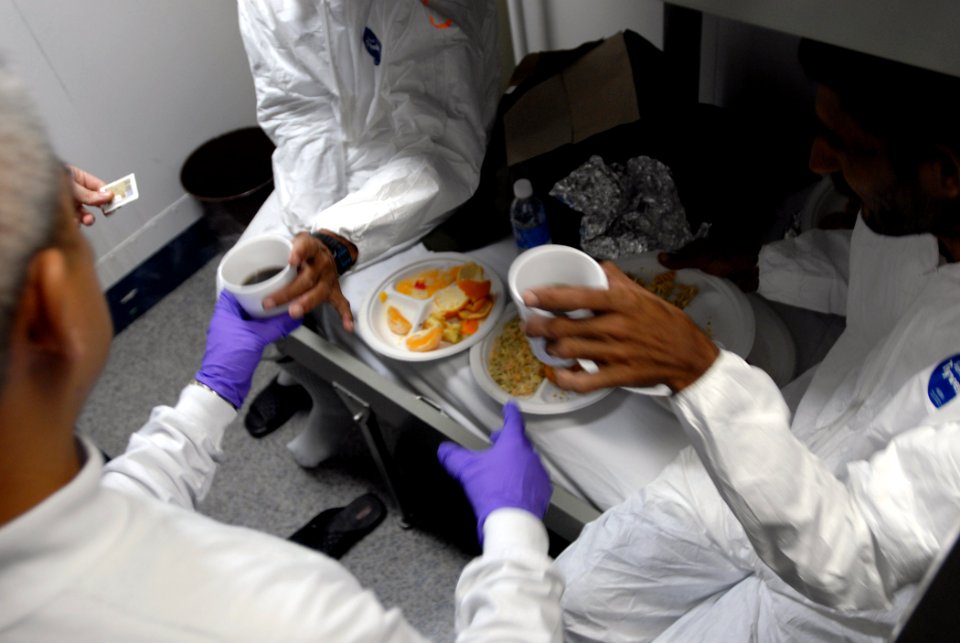 US Navy 071223-N-1688B-254 Hospital Corpsman 2nd class Homer Tabeta gives medical treatment, food and clothing to shipwreck survivors aboard the Nimitz-class nuclear-powered aircraft carrier USS Harry S. Truman (CVN 75)