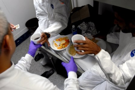 US Navy 071223-N-1688B-254 Hospital Corpsman 2nd class Homer Tabeta gives medical treatment, food and clothing to shipwreck survivors aboard the Nimitz-class nuclear-powered aircraft carrier USS Harry S. Truman (CVN 75)