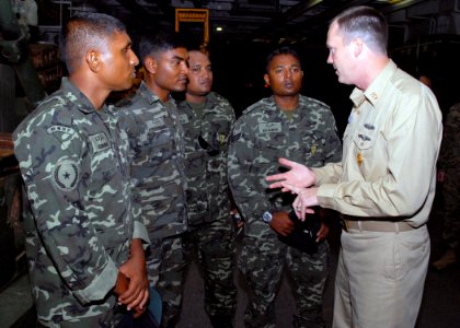 US Navy 071218-N-3925A-001 Command Master Chief William Steele briefs the capabilities of the amphibious transport dock USS Cleveland (LPD 7) to enlisted members of the Maldives National Defense Force photo