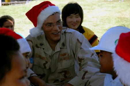 US Navy 071218-N-7367K-001 Senior Chief Builder E. Dan Walker, the senior enlisted leader of U.S. Naval Mobile Construction Battalion (NMCB) 1, Guam Det., trades hats with a student at Chief Brodie Memorial Elementary School