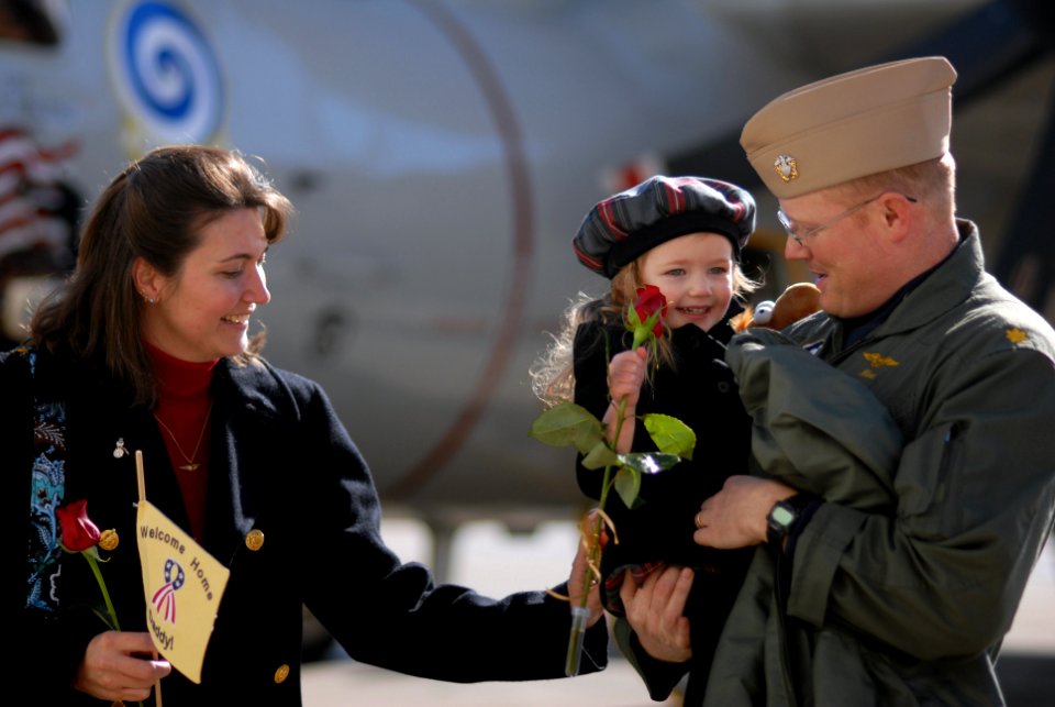 US Navy 071218-N-6081J-002 Lt. Cmdr. Kevin Downey, a Naval flight officer attached to Carrier Airborne Early Warning Squadron (VAW) 123, holds his daughter after returning home to Chambers Field on board Naval Station Norfolk