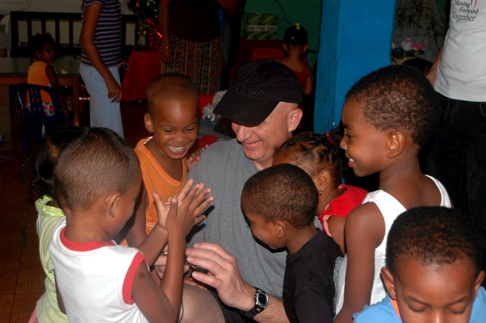 US Navy 071219-N-4014G-021 Command Master Chief Dominic Musso attached to the guided-missile destroyer USS Porter (DDG 78) interacts with children at a daycare, during a community relations project