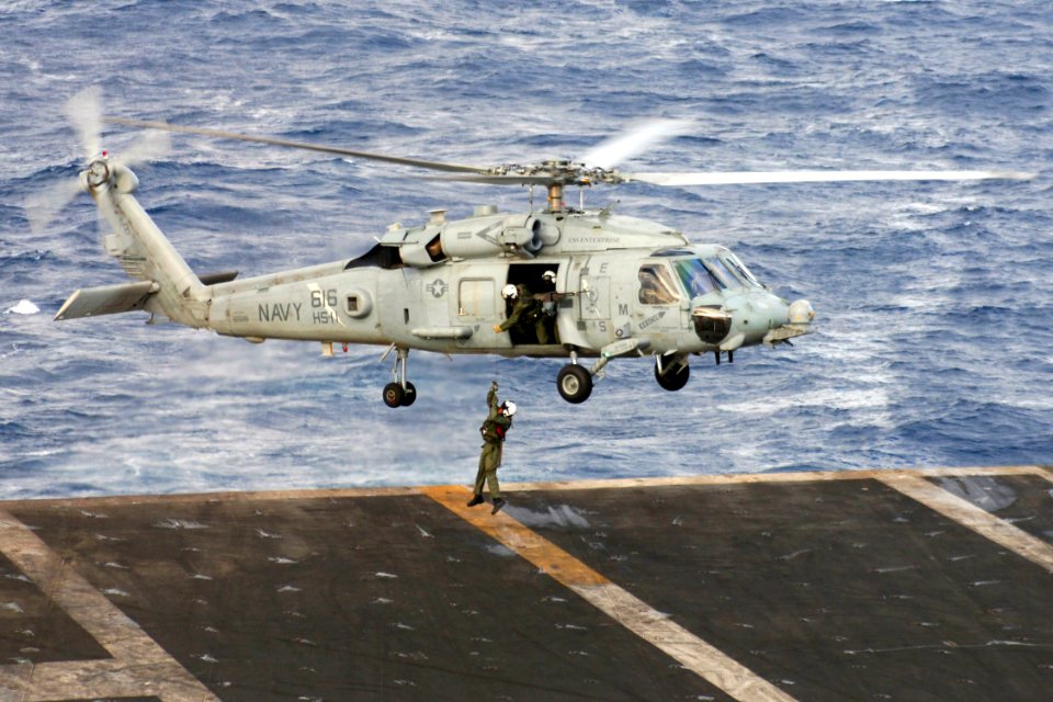 US Navy 071217-N-1598C-099 An aircrewman is lifted from the flight deck of the nuclear-powered aircraft carrier USS Enterprise (CVN 65) by an HH-60H Seahawk