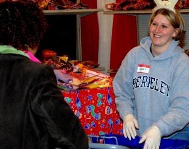 US Navy 071219-N-6724S-002 Interior Communications Technician 3rd Class Jennelle Hartman helps a deserving family load some Christmas gifts during the Salvation Army's Christmas Depot