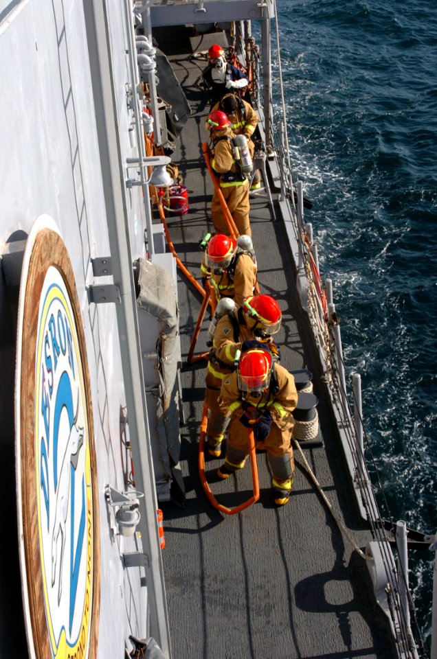 US Navy 071219-N-1831S-062 During a general quarters drill aboard the guided-missile frigate USS Carr (FFG 52) crew members charge hoses while approaching a simulated fire