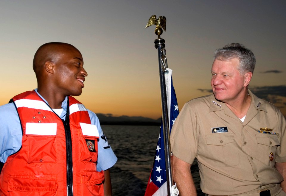 US Navy 071221-N-1125B-026 Chief of Naval Operations (CNO) Adm. Gary Roughead talks with Boatswains Mate 3rd Class Steven C. Love a crew member aboard the admirals barge GITMO 7