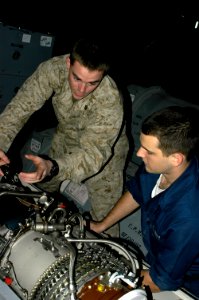 US Navy 071219-N-5033P-033 Sgt. Nathan Maasen and Aviation Machinist's Mate Airman Bryan Goodman serialize a T-58, turbo shaft engine for the CH-46E helicopter in the Hangar Bay of the amphibious assault ship USS Kearsarge (LHD