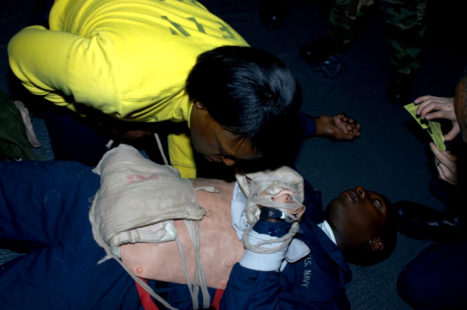 US Navy 071219-N-5033P-017 Aviation Boatswain's Mate Handler 1st Class Valentine Ngoma-Loembet participate in medical emergency training in flight deck triage aboard the amphibious assault ship USS Kearsarge (LHD 3)