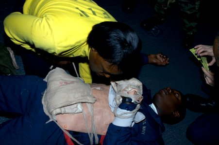 US Navy 071219-N-5033P-017 Aviation Boatswain's Mate Handler 1st Class Valentine Ngoma-Loembet participate in medical emergency training in flight deck triage aboard the amphibious assault ship USS Kearsarge (LHD 3)