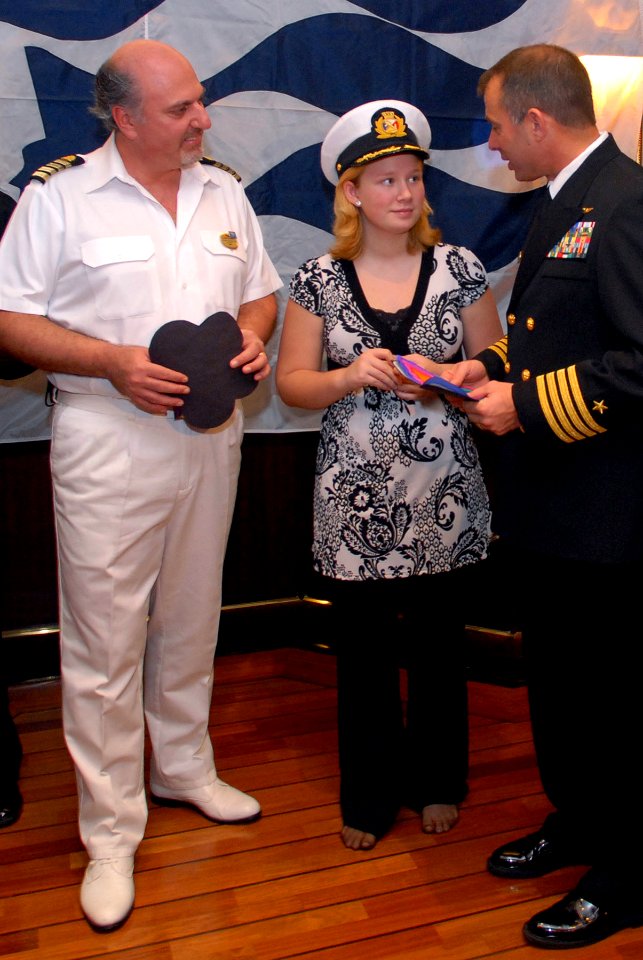 US Navy 080106-N-0555B-012 Laura Montero, center, speaks with Ronald Reagan Commanding Officer Capt. Terry B. Kraft, right, and Dawn Princess Commanding Officer Capt. Marco Fortezze during a luncheon