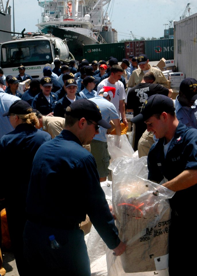 US Navy 071218-N-4014G-090 Sailors assigned to guided-missile destroyer USS Porter (DDG 78) sort mail on the pier after pulling into Port