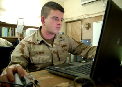 US Navy 071222-N-3857R-001 Personnel Specialist 3rd Class Ray Guedry, assigned to Naval Mobile Construction Battalion (NMCB) 1, manages the units pay and allowances on board Camp Ramadi