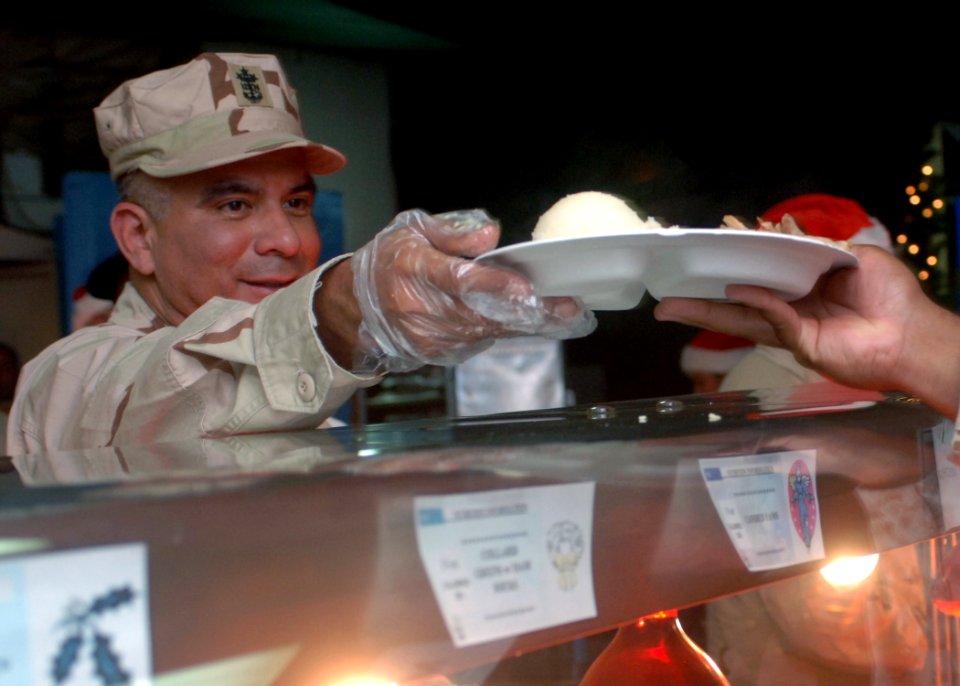 US Navy 071225-N-3285B-092 Master Chief Petty Officer of the Navy (MCPON) Joe R. Campa serves Christmas dinner to service members stationed at Combined Joint Task Force-Horn of Africa (CJTF-HOA)