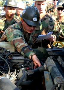 US Navy 071226-N-8547M-003 Equipment Operator 2nd Class Tony L. Cole gives training on the proper start up procedures of a high mobility multipurpose wheeled vehicle