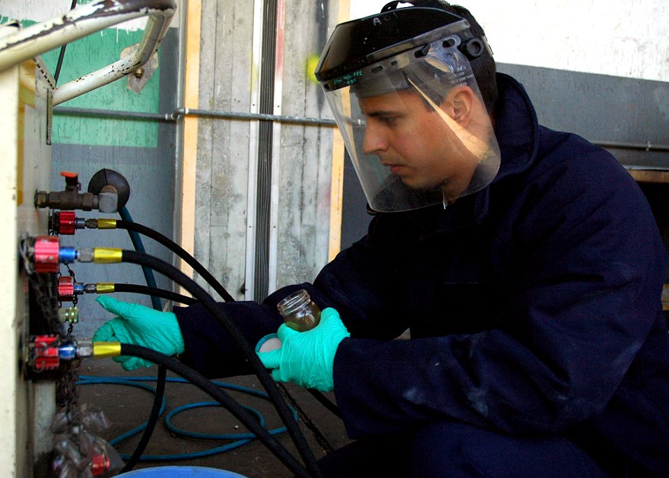 US Navy 080108-N-0577G-001 Aviation Support Equipment Technician 2nd Class Federico Munoz, from New York, prepares to take a hydraulic sample from a T-6 hydraulic dispensing unit