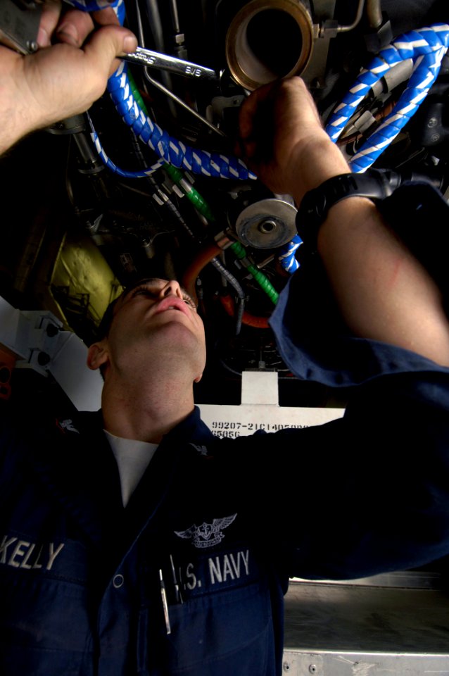 US Navy 080107-N-2880M-012 Aviation Machinist's Mate 3rd Class Timothy Kelly removes a rubber gasket from a jet engine air line