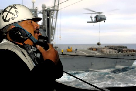 US Navy 080109-N-7526R-024 Chief Boatswain's Mate Dante Zamora relays information from the Military Sealift Command ammunition ship USNS Flint (T-AE 32)