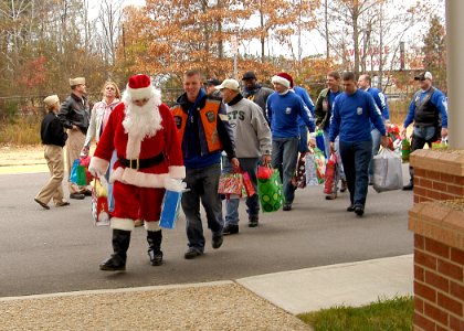 US Navy 071226-N-4669J-017 Santa and members of the motorcycle safety group of Strike Fighter Squadron (VFA) 143, arrive for a visit at the St. Mary's Home for Disabled Children