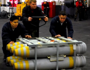 US Navy 080110-N-7526R-567 Sailors assigned to the weapons department of the Nimitz-class nuclear-powered aircraft carrier USS Ronald Reagan (CVN 76) move a pallet of ordnance through the hangar bay of the ship during an ammuni photo