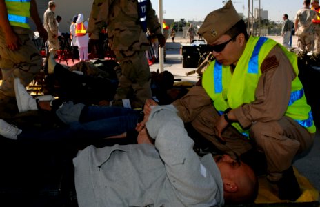US Navy 071227-N-4097B-043 Lt. Leon Que, a flight surgeon assigned to Naval Branch Health Clinic, tends to a simulated casualty during U.S. and Bahrain government agency crisis response exercise