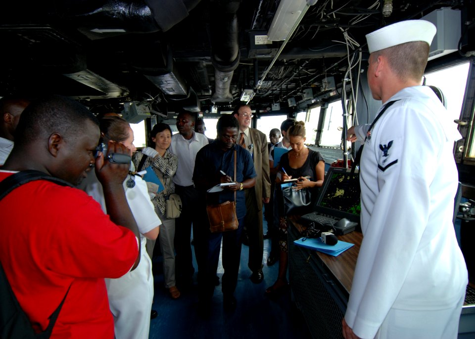 US Navy 080107-N-4044H-043 Electronics Technician Seaman Adam Soper explains the automated information system to international media aboard Africa Partnership Station dock landing ship USS Fort McHenry (LSD 43)