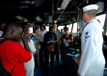 US Navy 080107-N-4044H-043 Electronics Technician Seaman Adam Soper explains the automated information system to international media aboard Africa Partnership Station dock landing ship USS Fort McHenry (LSD 43)
