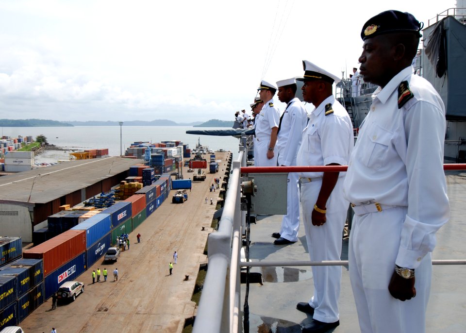 US Navy 080107-N-4044H-030 Cameroon Navy Petty Officer 3rd Class Edoh Mvondo and Chief Warrent Officer Mevo Jean Chrysostome man-the-rails aboard the amphibious dock landing ship USS Fort McHenry (LSD 43), while pulling in port