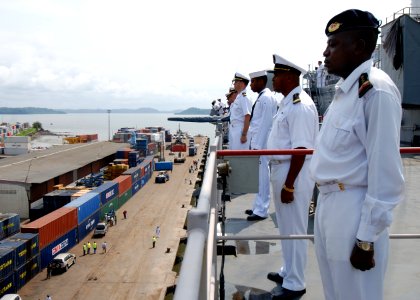US Navy 080107-N-4044H-030 Cameroon Navy Petty Officer 3rd Class Edoh Mvondo and Chief Warrent Officer Mevo Jean Chrysostome man-the-rails aboard the amphibious dock landing ship USS Fort McHenry (LSD 43), while pulling in port