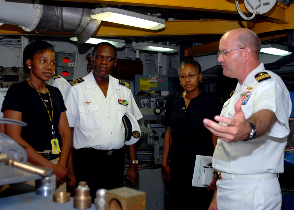 US Navy 080107-N-4044H-076 Cmdr. Martin Pompeo, commanding officer aboard Africa Partnership Station (APS) dock landing ship USS Fort McHenry (LSD 43), explains the procedure for fixing a metal antenna bracket for a rigid hull