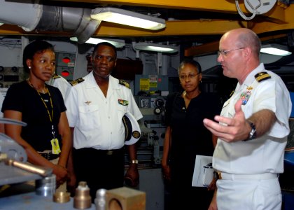 US Navy 080107-N-4044H-076 Cmdr. Martin Pompeo, commanding officer aboard Africa Partnership Station (APS) dock landing ship USS Fort McHenry (LSD 43), explains the procedure for fixing a metal antenna bracket for a rigid hull