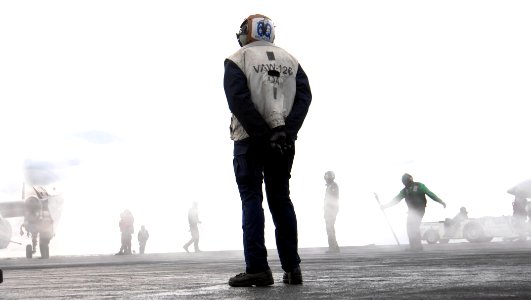 US Navy 080104-N-7364R-193 A sailor assigned to Carrier Airborne Warning Squadron (VAW) 126 observes flight operations aboard the Nimitz-Class nuclear powered aircraft carrier USS Harry S. Truman (CVN 75)