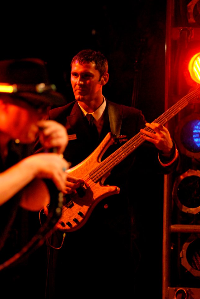 US Navy 080112-N-0555B-176 Lt. Jared Gianquinto, a dental officer assigned to the Nimitz-class nuclear-powered aircraft carrier USS Ronald Reagan (CVN 76), plays an electric bass guitar with the band