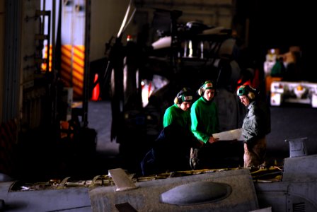 US Navy 080108-N-1688B-021 Sailors look over maintenance that was performed in the hangar bay of the Nimitz-class nuclear-powered aircraft carrier USS Harry S. Truman (CVN 75)