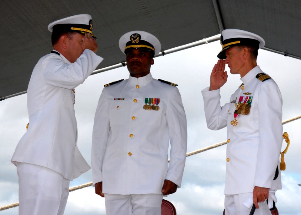 US Navy 080104-N-9758L-137 Capt. William Kearns III, commodore, Destroyer Squadron (DESRON) 31, salutes Capt. Robert Stewart as he officially takes command during a change of command ceremony for DESRON-31 held on board Naval S