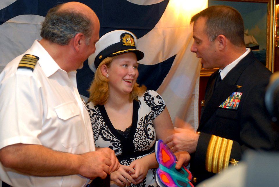 US Navy 080106-N-0555B-013 Laura Montero, center, speaks with Ronald Reagan Commanding Officer Capt. Terry B. Kraft, right, and Dawn Princess Commanding Officer Capt. Marco Fortezze during a luncheon