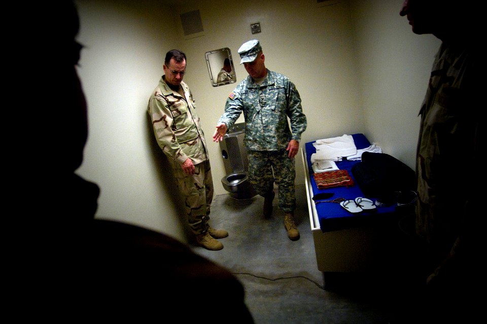 US Navy 080113-N-0696M-139 Col. Bruce Vargo, the joint detention group commander at Guantanamo Bay, gives a tour of a detainee holding cell to Adm. Mike Mullen, Chairman of the Joint Chiefs of Staff