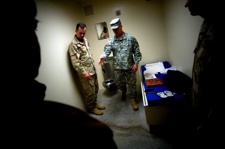 US Navy 080113-N-0696M-139 Col. Bruce Vargo, the joint detention group commander at Guantanamo Bay, gives a tour of a detainee holding cell to Adm. Mike Mullen, Chairman of the Joint Chiefs of Staff