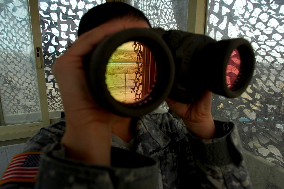 US Navy 080109-N-0292S-002 U. S. Army Specialist Jessica Jessee, of BSB Infantry Support Security Force (SECFOR) scans the terrain while standing watch