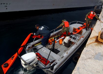 US Navy 080109-N-0780F-006 Sailors assigned to Naval Support Activity Port Operations, Souda Bay deploy an oil spill containment boom around guided missile destroyer USS Laboon (DDG 58) prior to refueling operations photo