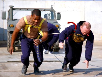 US Navy 080112-N-7367K-012 Utilitiesman Constructionman Michael Holman, left, and Steelworker 2nd Class Michael Bales, both assigned to Naval Mobile Construction Battalion (NMCB) 15, work together to pull a Humvee
