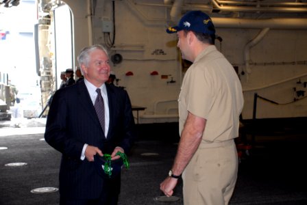 US Navy 080107-N-9909C-003 Cmdr. Brad Skillman, commanding officer of USS New Orleans (LPD 18), presents Defense Secretary Robert M. Gates with a command ball cap and a set of traditional Mardi Gras beads following a tour and l photo