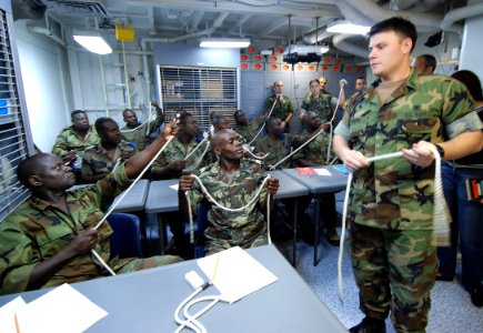 US Navy 080111-N-4044H-001 Boatswain's Mate 1st Class Tracy Bivins explains basic knot tying techniques to Gabonese sailors as part of training by Africa Partnership Station (APS) photo