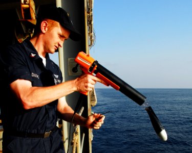 US Navy 080109-N-8933S-044 Aerographer's Mate 3rd Class Brandon Davis launches a Sippican MK-2 bathythermograph data acquisition system