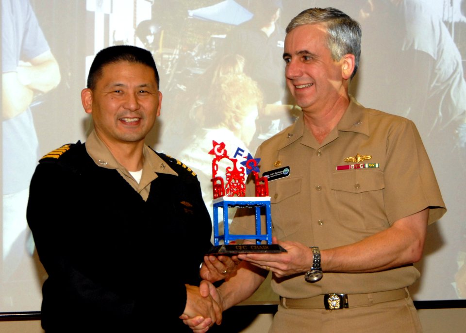 US Navy 080111-N-7656R-002 Capt. Reid Tanaka, commanding officer of Naval Base Kitsap, turns over the Combined Federal Campaign (CFC)