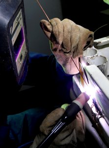 US Navy 080108-N-0455L-001 Aviation Structural Mechanic 2nd Class Jason Knapp performs a tig weld on a B1 stand aboard the aircraft carrier USS Harry S. Truman (CVN 75)